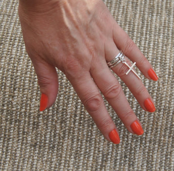 Cross pendant stacker ring set.