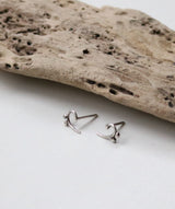 Bass clef studs.  Two variations